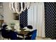 Dining room with navy velvet chairs, table set, white & navy curtains, and modern lighting at 2659 Vegas Valley Dr, Las Vegas, NV 89121