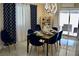 Stylish dining area featuring a table set for a meal, modern light fixture, and elegant decor at 2659 Vegas Valley Dr, Las Vegas, NV 89121