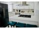 Modern kitchen with stainless steel appliances, white cabinets, and stylish bar seating creating a functional cooking space at 2659 Vegas Valley Dr, Las Vegas, NV 89121