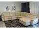 Spacious living room featuring a white leather sectional sofa, textured rug, and decorative curtains at 2659 Vegas Valley Dr, Las Vegas, NV 89121