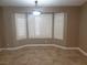 Dining area features tiled floors, modern chandelier, and bright bay windows at 3116 Gentle Breeze St, Las Vegas, NV 89108