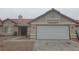 Single-story home with a two-car garage, desert landscaping, and neutral color palette at 3116 Gentle Breeze St, Las Vegas, NV 89108