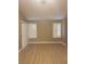 Bright living room features wood-look floors and shuttered windows, creating a modern and inviting space at 3116 Gentle Breeze St, Las Vegas, NV 89108