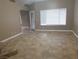 Open living space with tile flooring and a glass door leading to the outside at 3116 Gentle Breeze St, Las Vegas, NV 89108