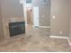 Open-concept living room featuring a tile fireplace, neutral walls, and tile flooring at 3116 Gentle Breeze St, Las Vegas, NV 89108