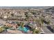 Wide aerial view of the community showing pool, landscaping, and surrounding homes against a distant horizon at 3161 Quail Song Dr # 3161, Laughlin, NV 89029