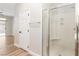 Bathroom showcasing the glass-enclosed shower, and access to the primary bedroom at 3161 Quail Song Dr # 3161, Laughlin, NV 89029
