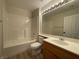 Bathroom featuring a vanity with a wood cabinet and a shower-tub combo at 3161 Quail Song Dr # 3161, Laughlin, NV 89029