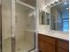 Bathroom featuring a glass-enclosed shower and updated vanity with a large mirror at 3161 Quail Song Dr # 3161, Laughlin, NV 89029