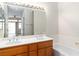 Bathroom view showing a double sink vanity, a large mirror, and a shower-tub combination at 3161 Quail Song Dr # 3161, Laughlin, NV 89029