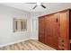 Bedroom featuring a murphy bed, custom cabinetry, and wood-look floors at 3161 Quail Song Dr # 3161, Laughlin, NV 89029