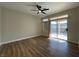 Bedroom with modern ceiling fan, sliding door, and wood-look floors at 3161 Quail Song Dr # 3161, Laughlin, NV 89029