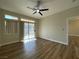Bedroom with modern ceiling fan, sliding door, and wood-look floors at 3161 Quail Song Dr # 3161, Laughlin, NV 89029