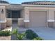 Inviting home exterior with a neutral color palette, landscaped yard, and charming gated courtyard entrance at 3161 Quail Song Dr # 3161, Laughlin, NV 89029