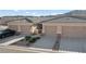 Charming townhome featuring a neutral color scheme, attached garage and low-maintenance landscaping at 3161 Quail Song Dr # 3161, Laughlin, NV 89029