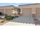 Exterior view of a home featuring a two car garage, desert landscaping, and mountain views at 3161 Quail Song Dr # 3161, Laughlin, NV 89029