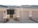 Exterior view of a neutral colored home featuring a two car garage, desert landscaping, and mountain views at 3161 Quail Song Dr # 3161, Laughlin, NV 89029