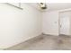 Large garage featuring auto door opener, sealed concrete flooring, and access door to exterior at 3161 Quail Song Dr # 3161, Laughlin, NV 89029