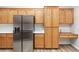Spacious kitchen with wood cabinets, stainless steel refrigerator and built-in desk area at 3161 Quail Song Dr # 3161, Laughlin, NV 89029
