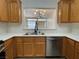 Bright kitchen featuring a stainless steel dishwasher and a pass-through window at 3161 Quail Song Dr # 3161, Laughlin, NV 89029