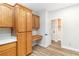 Kitchen cabinets with built-in desk and doorway to laundry room at 3161 Quail Song Dr # 3161, Laughlin, NV 89029