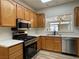 Well-lit kitchen featuring stainless steel appliances, oak cabinets, and bright countertops at 3161 Quail Song Dr # 3161, Laughlin, NV 89029