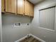 Laundry room equipped with overhead cabinets and a window for natural light at 3161 Quail Song Dr # 3161, Laughlin, NV 89029