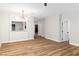 Open living room with wood floors, modern lighting, and view into other rooms at 3161 Quail Song Dr # 3161, Laughlin, NV 89029