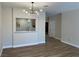 Open-concept living room with wood floors, modern lighting, and a passthrough to the kitchen at 3161 Quail Song Dr # 3161, Laughlin, NV 89029