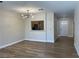Open-concept living room with wood floors, modern lighting, and a passthrough to the kitchen at 3161 Quail Song Dr # 3161, Laughlin, NV 89029