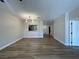 Open-concept living room with wood floors, modern lighting, and a passthrough to the kitchen at 3161 Quail Song Dr # 3161, Laughlin, NV 89029