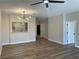 Open-concept living room with wood floors, modern lighting, and a passthrough to the kitchen at 3161 Quail Song Dr # 3161, Laughlin, NV 89029