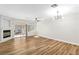 Spacious living room with wood floors, fireplace, sliding glass doors, and modern lighting at 3161 Quail Song Dr # 3161, Laughlin, NV 89029
