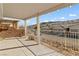 Covered patio featuring a mountain view, white posts, and metal fencing at 3161 Quail Song Dr # 3161, Laughlin, NV 89029
