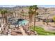 Gorgeous aerial view of community pool and recreation area with putting green and lush landscaping at 3161 Quail Song Dr # 3161, Laughlin, NV 89029