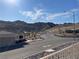 Scenic street view showcases desert landscaping and majestic mountain backdrop in a desirable neighborhood at 3161 Quail Song Dr # 3161, Laughlin, NV 89029