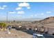 Community street view showing garages and mountain views on a sunny day at 3161 Quail Song Dr # 3161, Laughlin, NV 89029