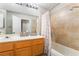 Bathroom featuring a double sink vanity, tile surround shower and a shower curtain at 3221 Yolanda Ln, Las Vegas, NV 89121