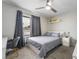 This bedroom features a ceiling fan, modern window treatments, and neutral paint at 3221 Yolanda Ln, Las Vegas, NV 89121