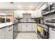 Updated kitchen showcases white cabinetry, stainless appliances, and black countertops at 3221 Yolanda Ln, Las Vegas, NV 89121