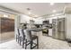 Modern kitchen features stainless steel appliances, white cabinetry, and stylish breakfast bar at 3221 Yolanda Ln, Las Vegas, NV 89121