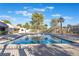 Community pool featuring crystal-clear water, surrounded by mature trees and landscaping at 3221 Yolanda Ln, Las Vegas, NV 89121
