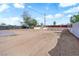A spacious dirt backyard with a mature tree and a concrete foundation is perfect for customization and outdoor living at 3509 Navajo Way, Las Vegas, NV 89108