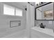 Beautifully remodeled bathroom featuring new fixtures, subway tile, and a tub with shower at 3509 Navajo Way, Las Vegas, NV 89108