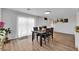 Spacious dining area featuring wood-look flooring and a view of the living room and kitchen at 3509 Navajo Way, Las Vegas, NV 89108