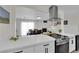 Bright kitchen featuring white cabinets, stainless steel appliances, and an open layout to the dining area at 3509 Navajo Way, Las Vegas, NV 89108