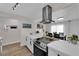 Modern kitchen design with white countertops, stainless steel appliances, and a dining area in the background at 3509 Navajo Way, Las Vegas, NV 89108