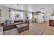 Bright and airy living room featuring an oversized couch, open to the modern kitchen with hardwood floors at 3509 Navajo Way, Las Vegas, NV 89108