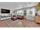 Bright living room with a large window, hardwood floors, comfortable seating, and a flatscreen TV at 3509 Navajo Way, Las Vegas, NV 89108