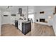 Open-concept living space with a modern kitchen, dining area, and a cozy fireplace, creating a warm atmosphere at 3509 Navajo Way, Las Vegas, NV 89108